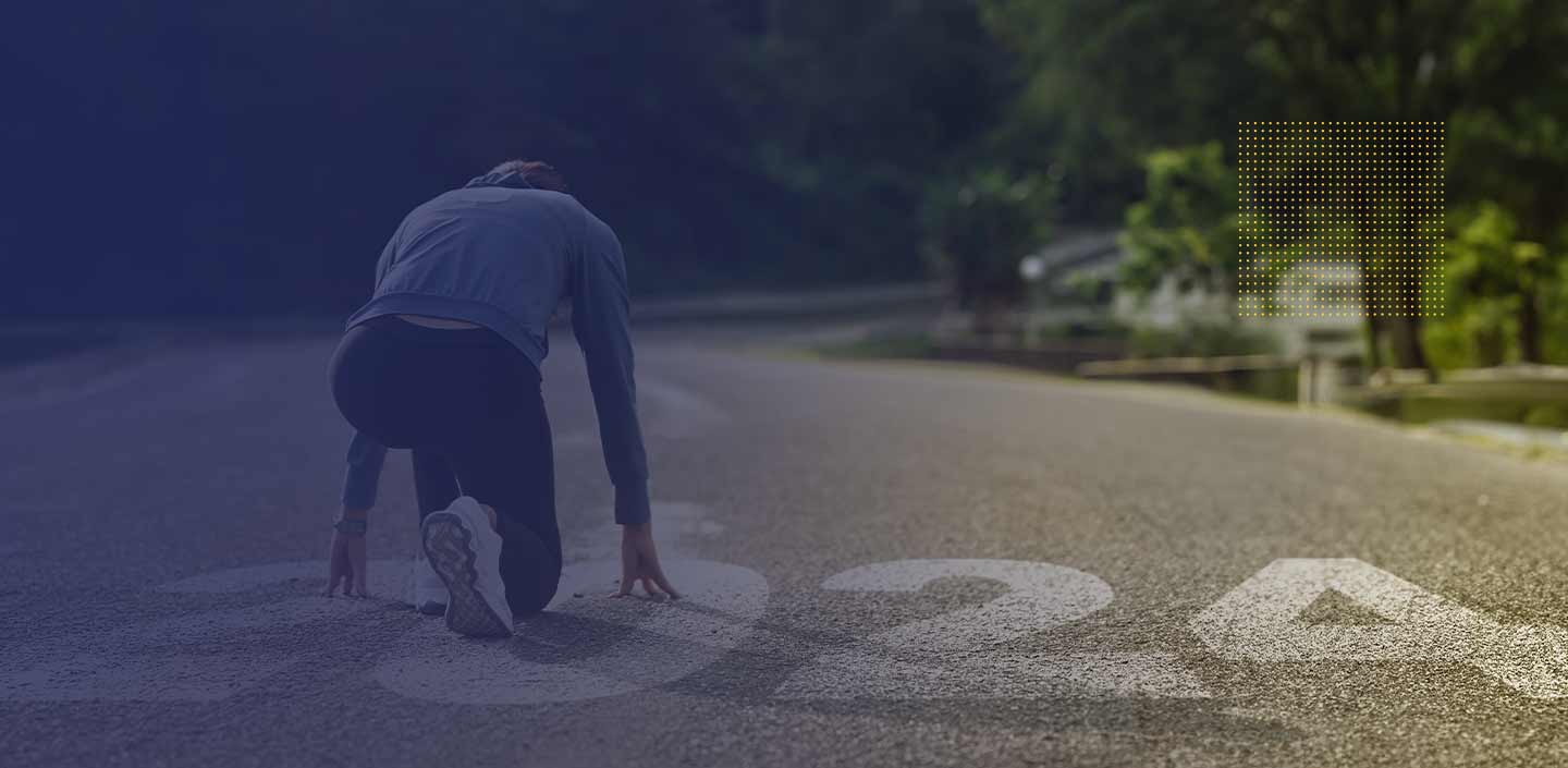 Iemand die zijn dag begint met hardlopen in de bergen, genietend van de frisse lucht en een hogere hartslag voor een beter welzijn in 2024.