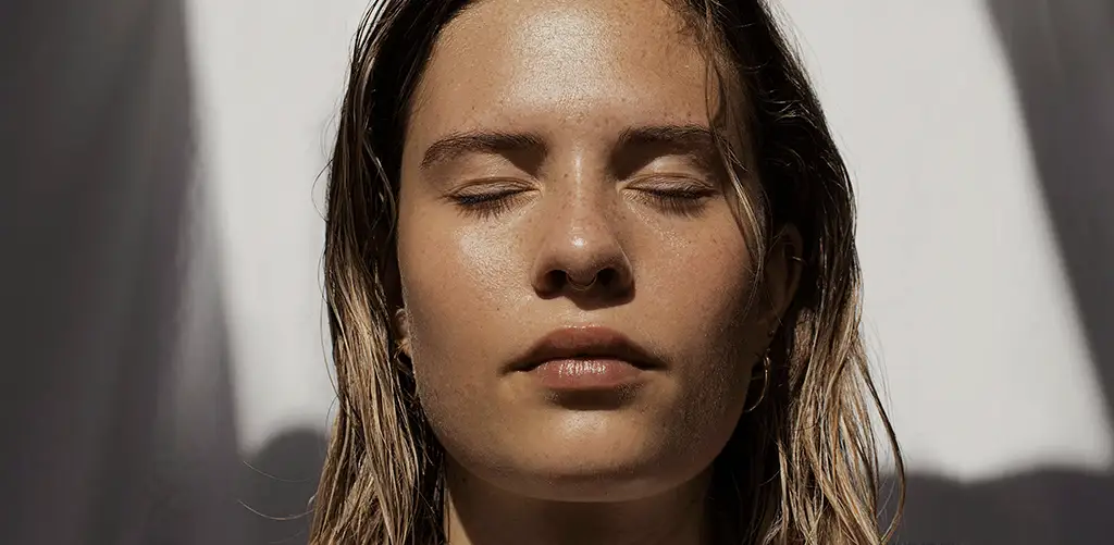 close up of a womans face and smooth skin
