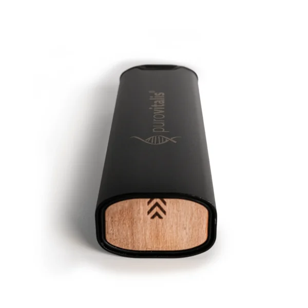 Purovitalis metal pill organiser with seven daily compartments, secure silicone closure, and natural wood inlay, shown in black with capsules inside.
