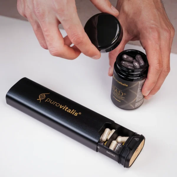 Hands opening a Purovitalis NAD+ bottle beside the black pill organizer on a table