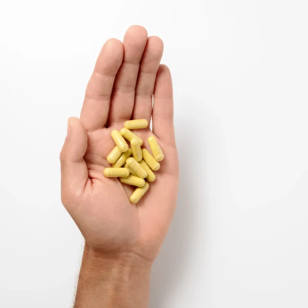 Liposomal Quercetin capsules in an open hand