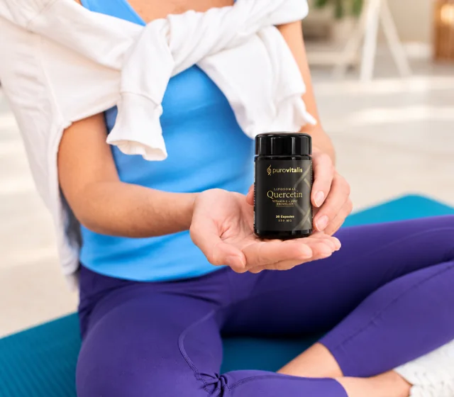 Woman holding Liposomal Quercetin after training